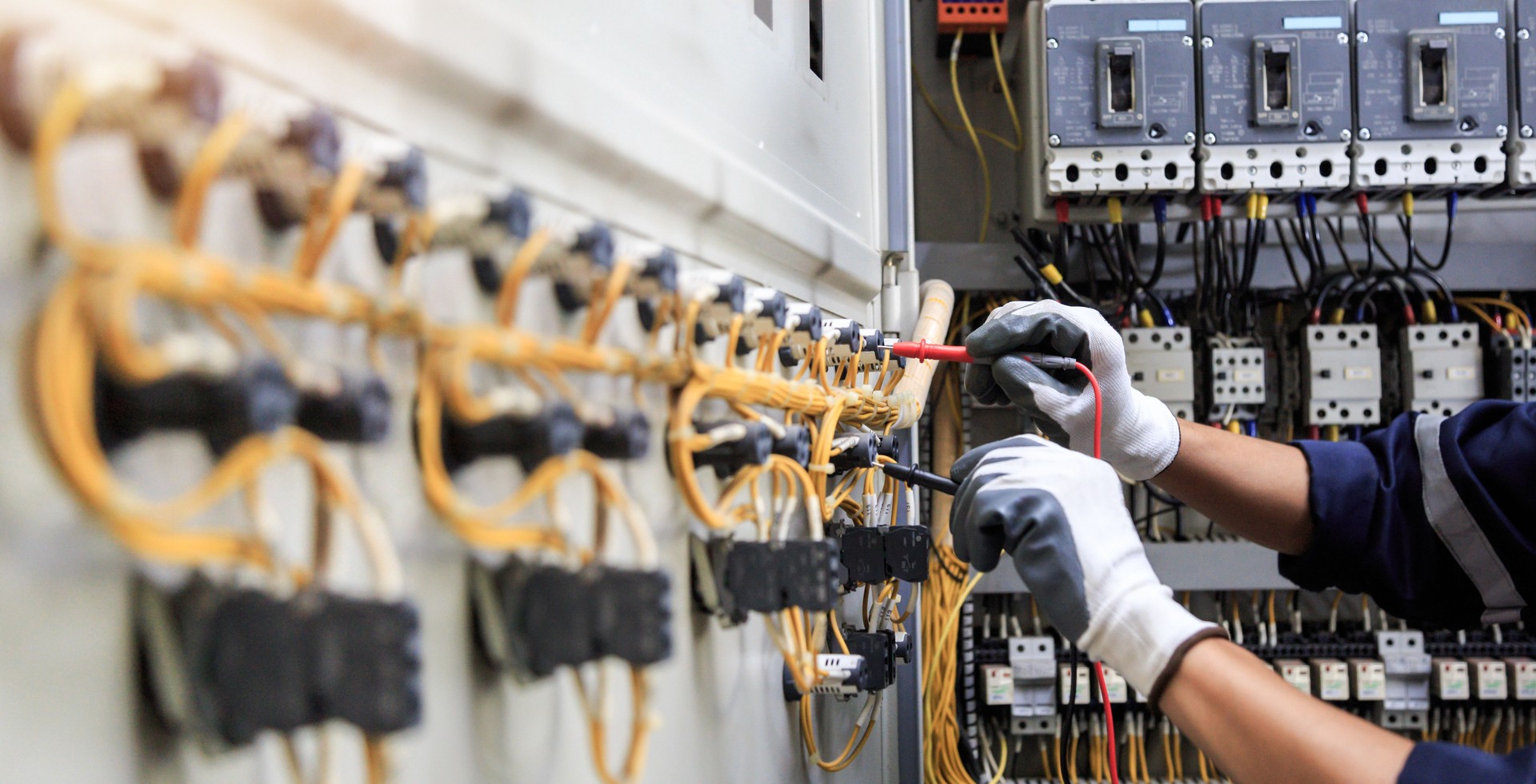 Electrician use meters to measure current at devices in the MDB cabinet, for safety in the electrical system.